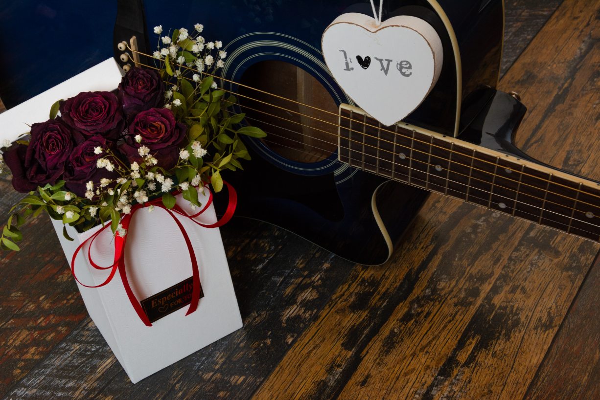Box of roses and guitar gifts for music lovers